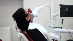 a woman receiving teeth whitening treatment