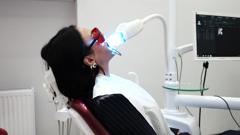 a woman receiving teeth whitening treatment