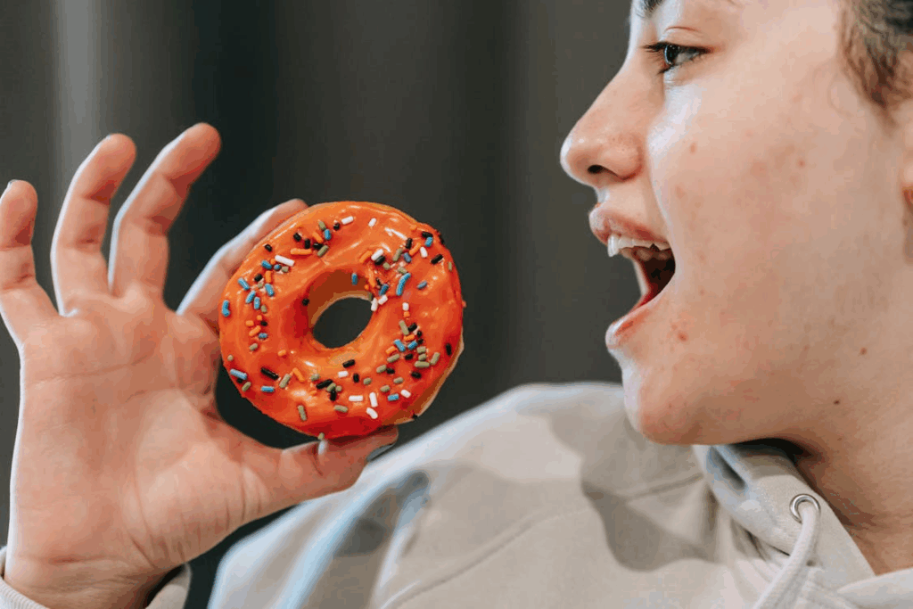 a woman about to eat a donut