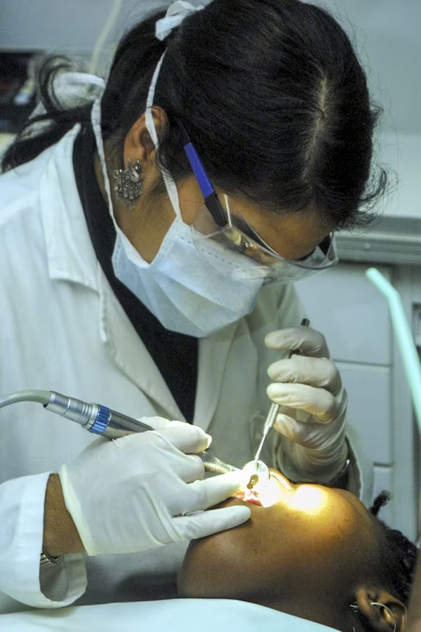 a dental professional working on a patient