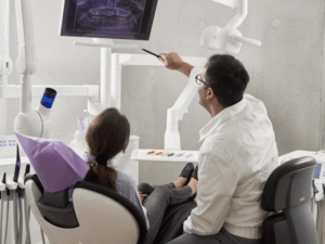 a dentist explaining a dental x-ray to his patient