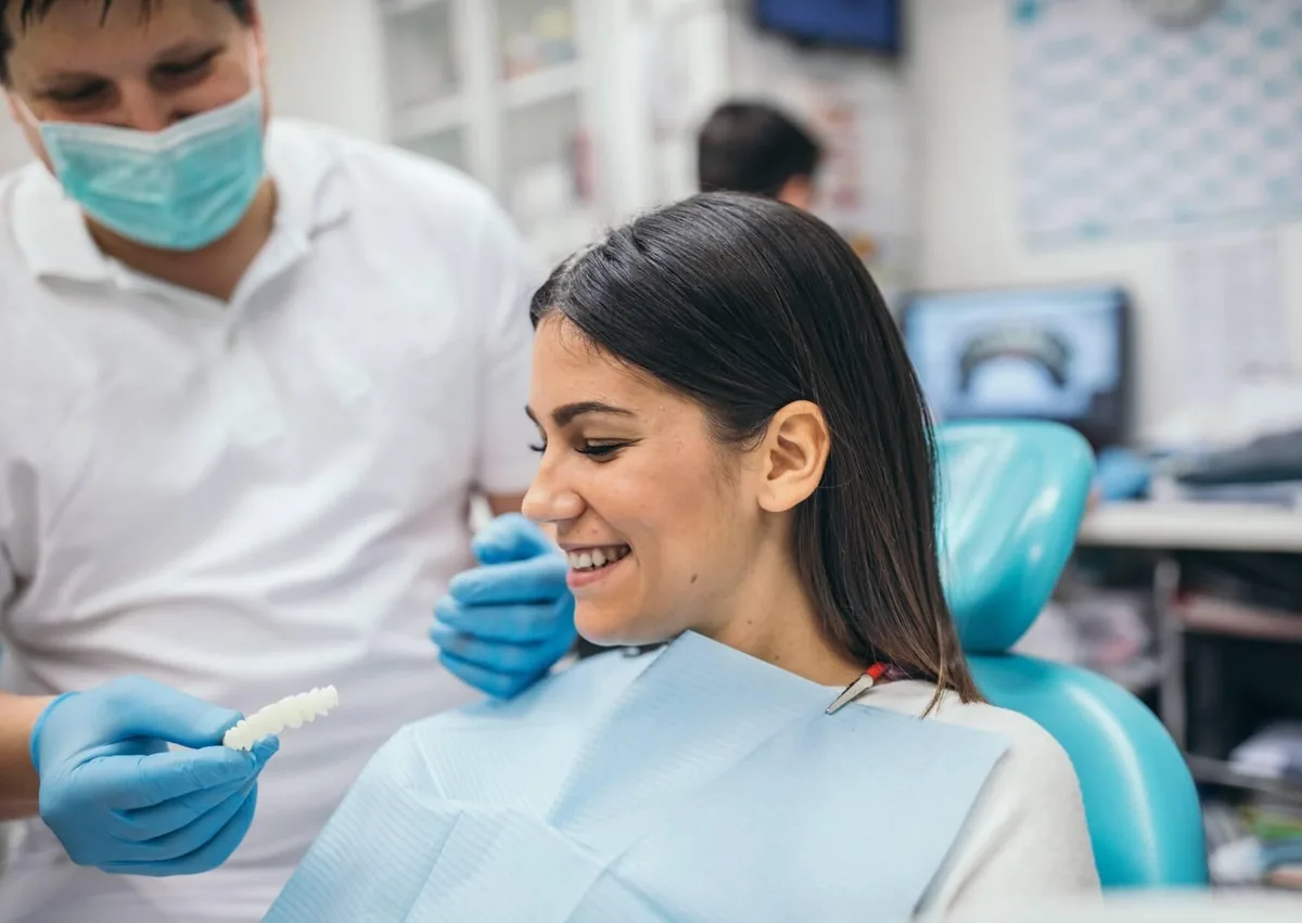 Dentist discussing smile makeover options with a patient to improve the appearance of her teeth.