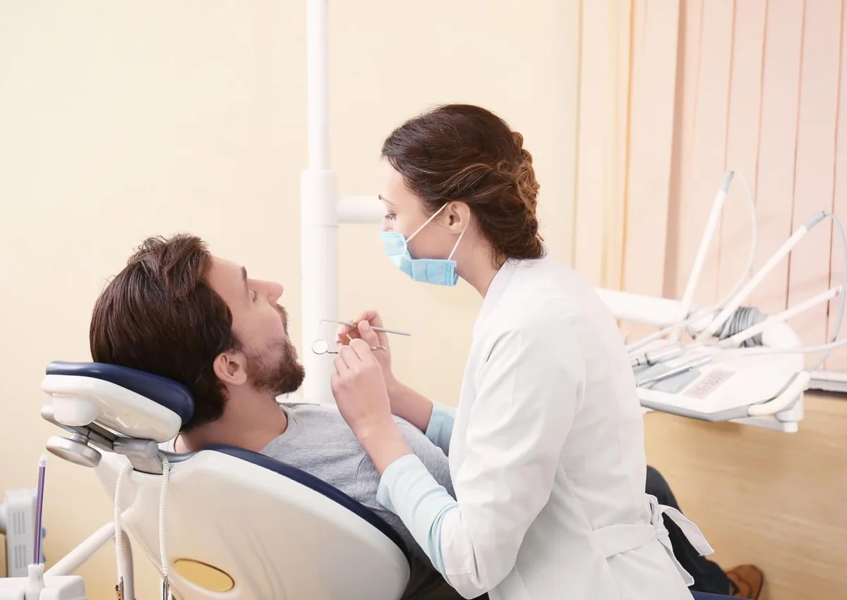 Dentist examining a patient’s teeth for visible signs of cavities and tooth decay.
